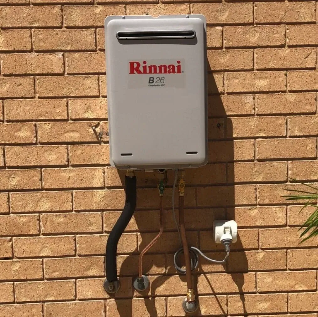 Gas continuous flow hot water unit on a brick wall