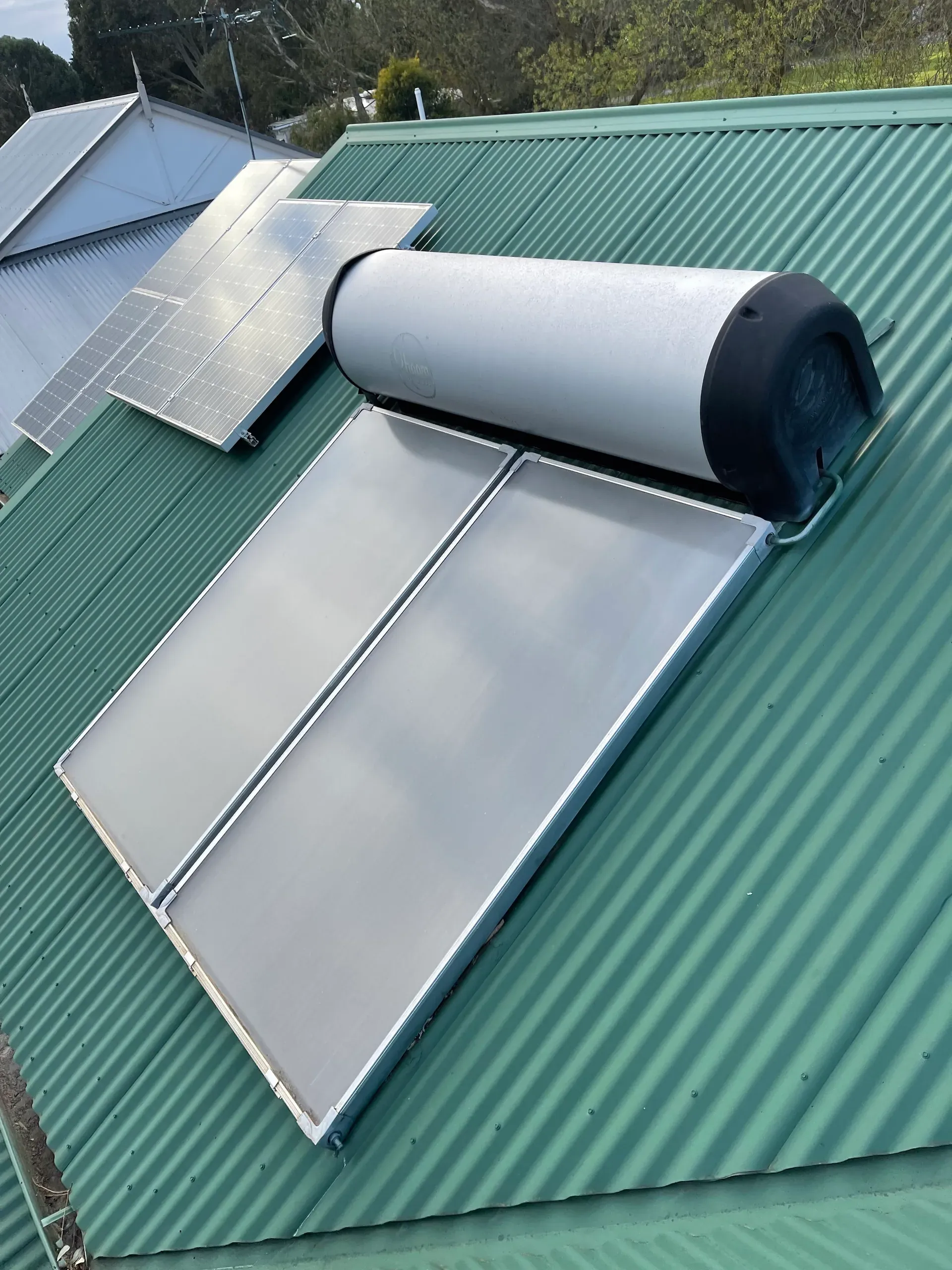 Solar hot water panels and tank on a metal roof
