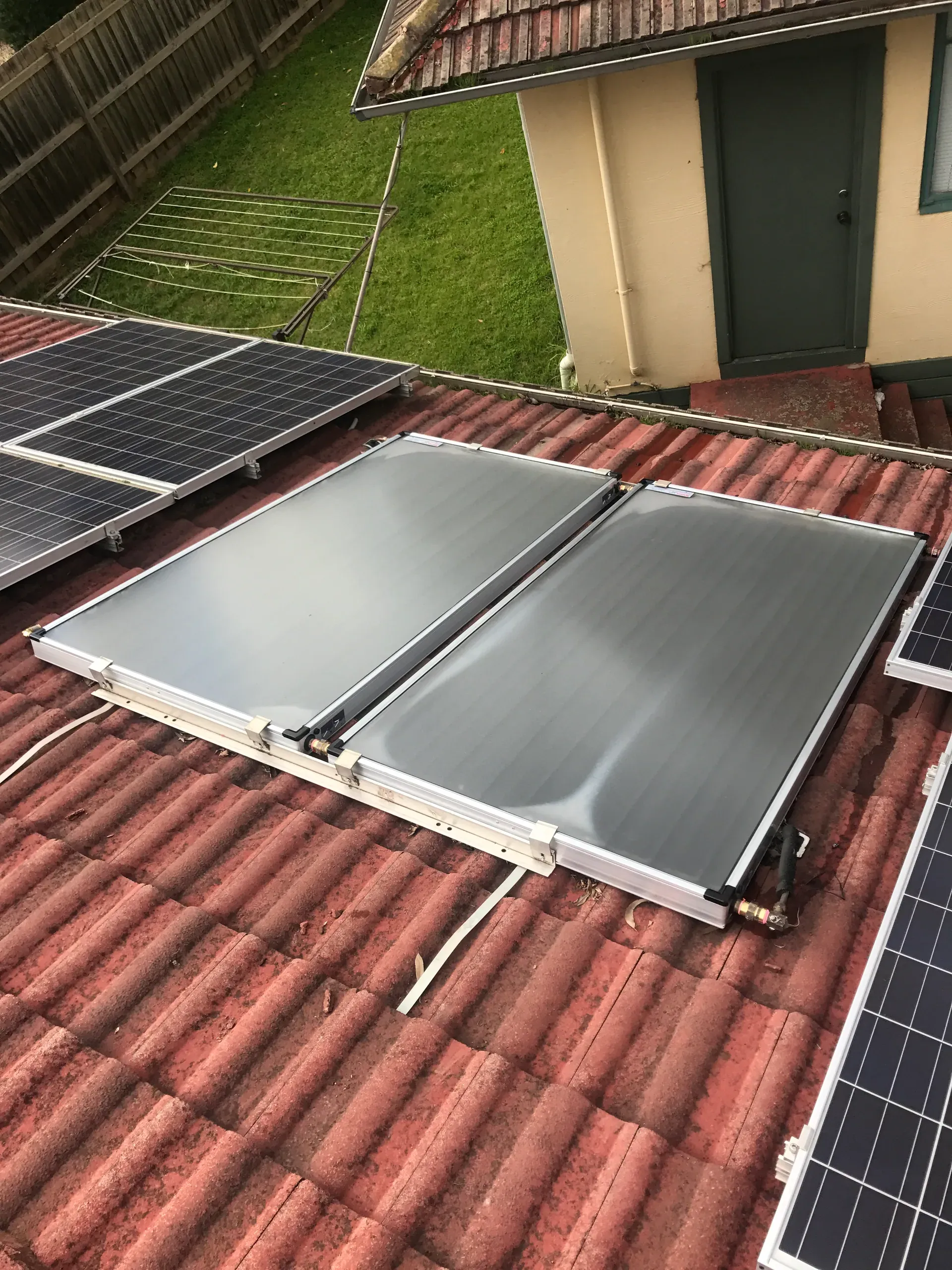 Flat plate solar hot water panels on a tiled roof