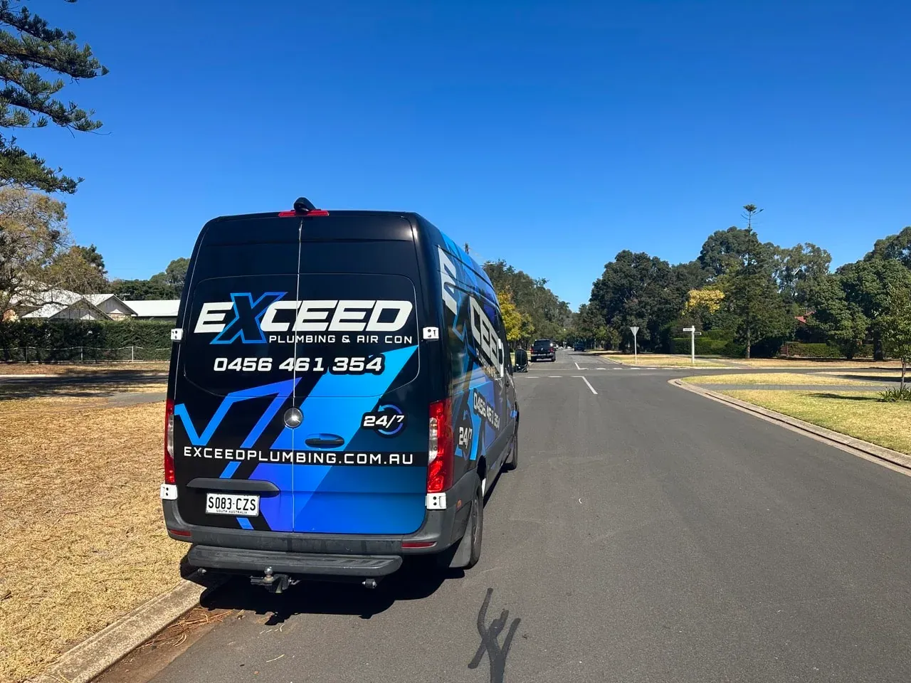 The Exceed Plumbing van parked on a tree-lined street in Colonel Light Gardens