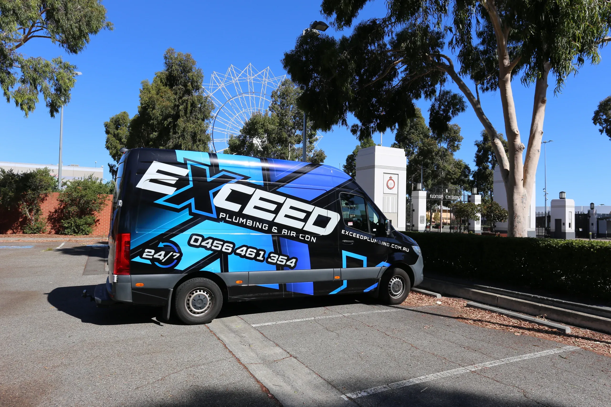 The Exceed Plumbing van parked in the sun under gum trees
