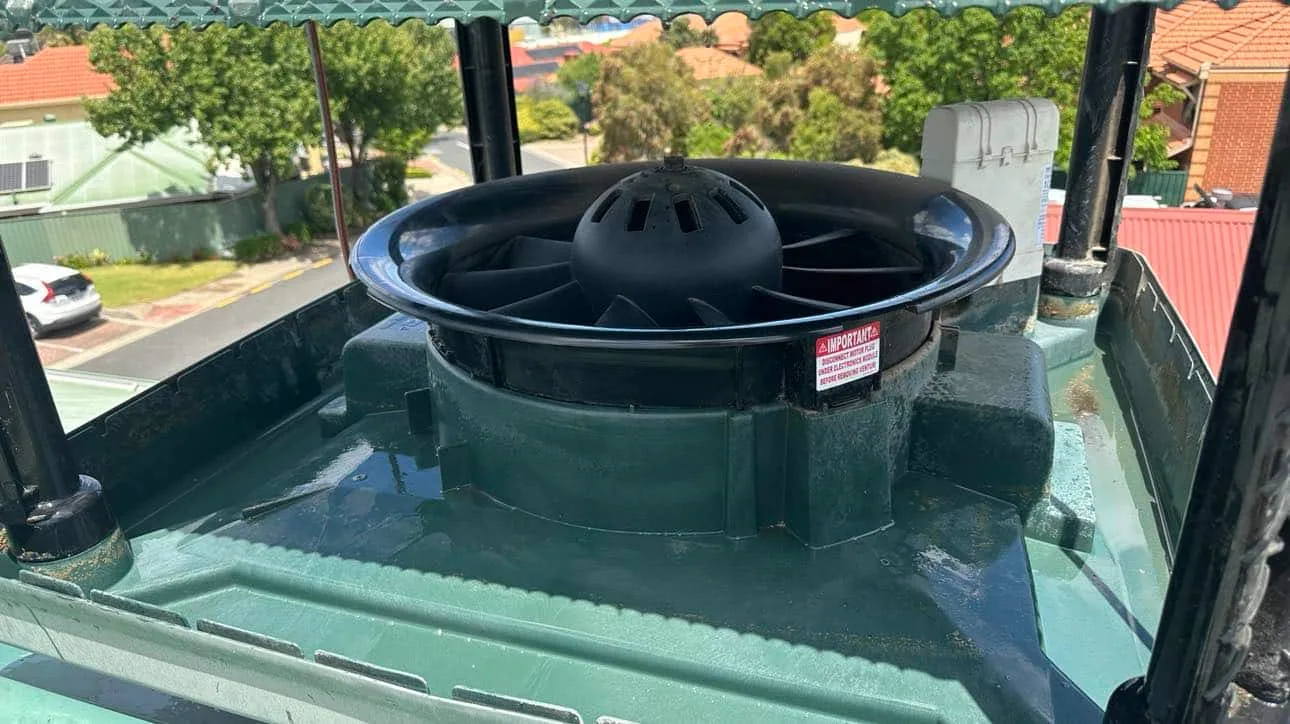 Evaporative cooler with the lid off, showing the fan