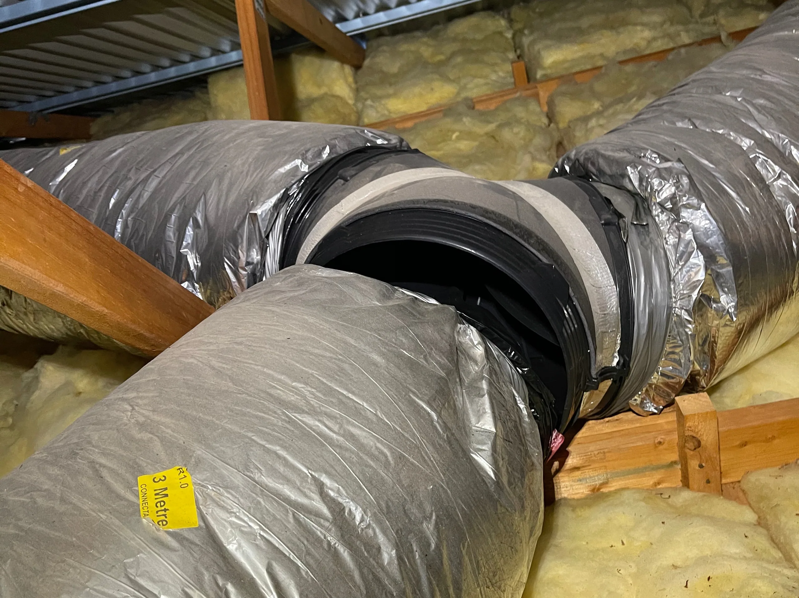 Insulated flexible ducting joined in a roof space