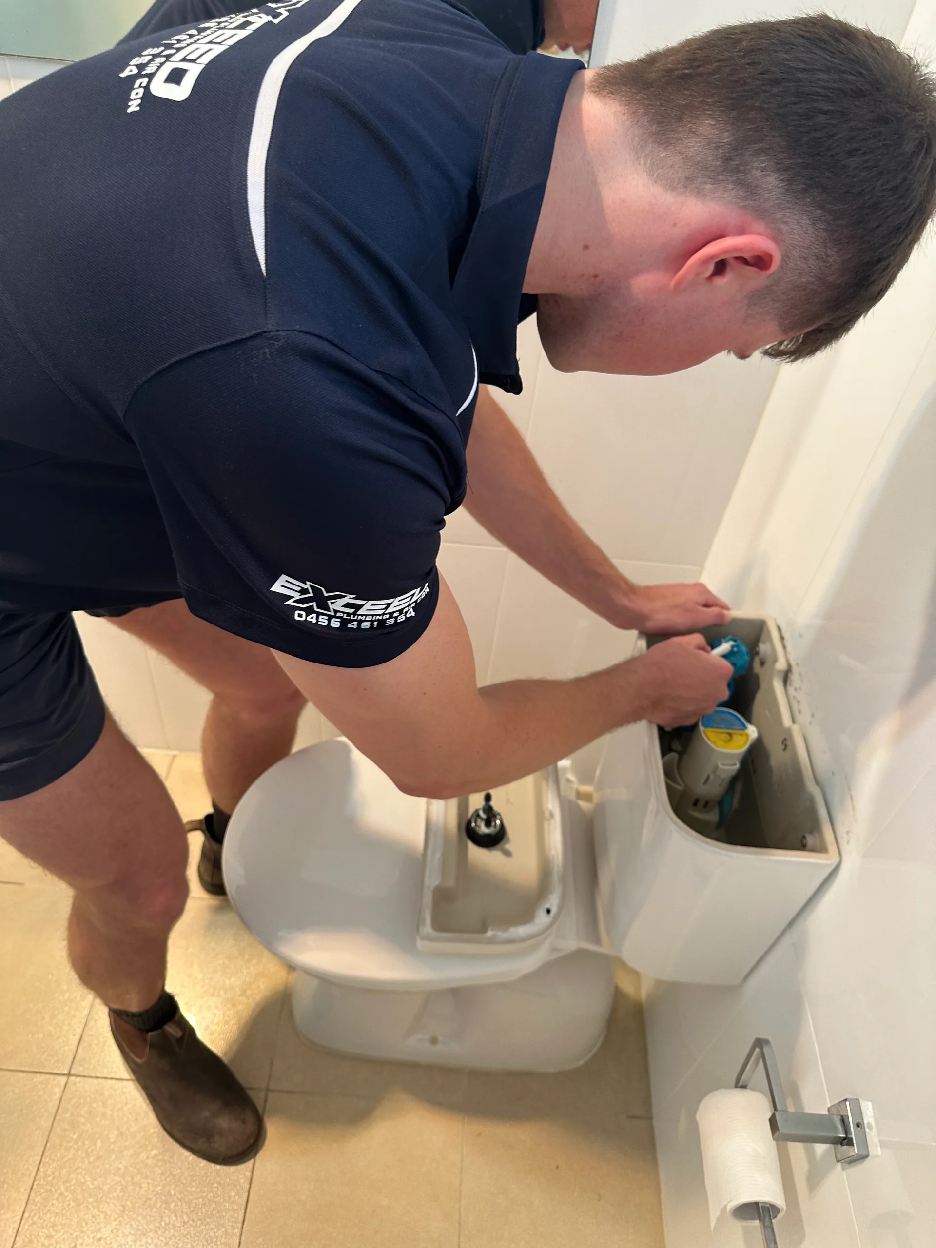 Exceed Plumbing plumber repairing a toilet cistern