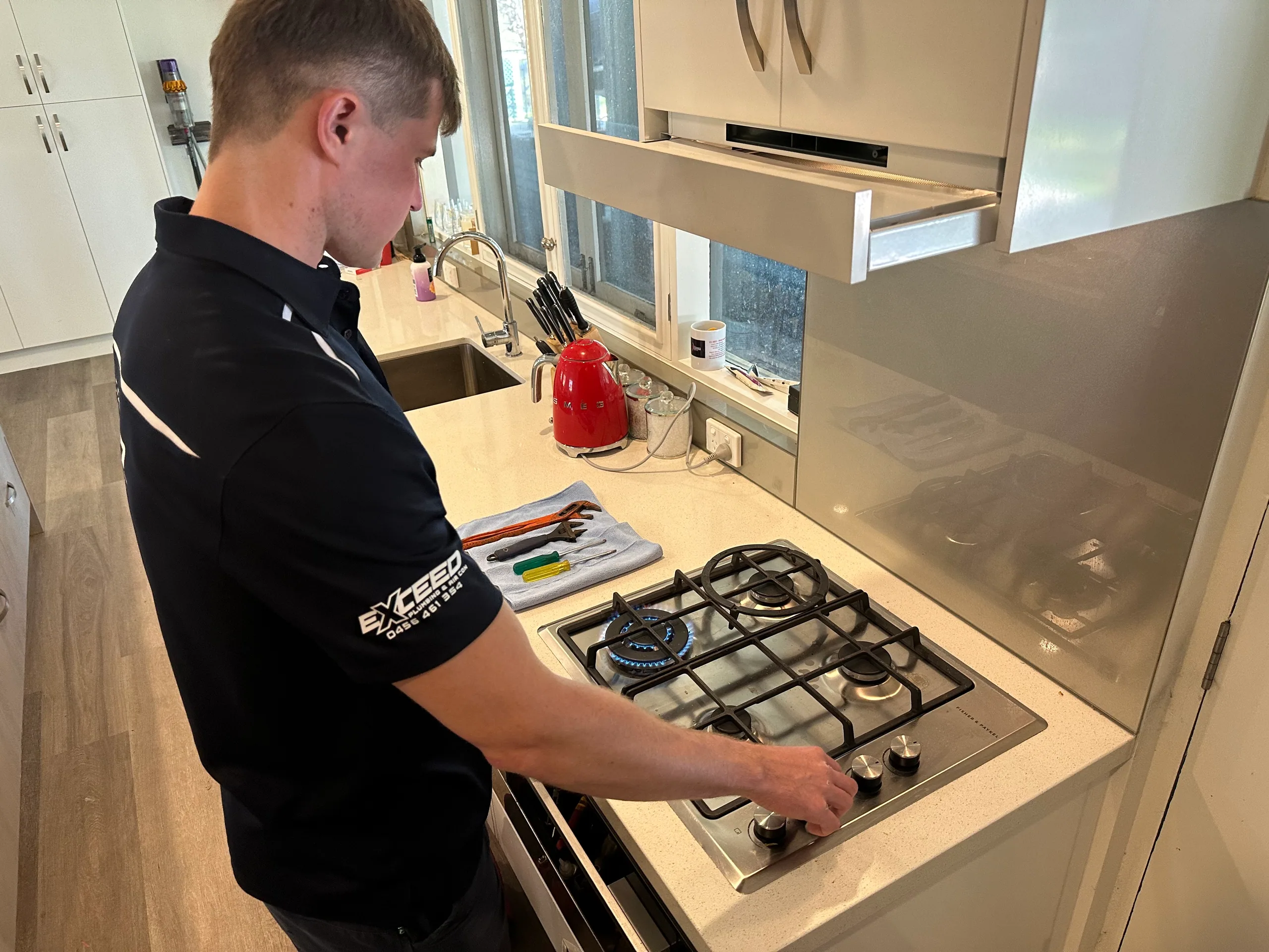 Exceed Plumbing plumber checking a gas cooktop