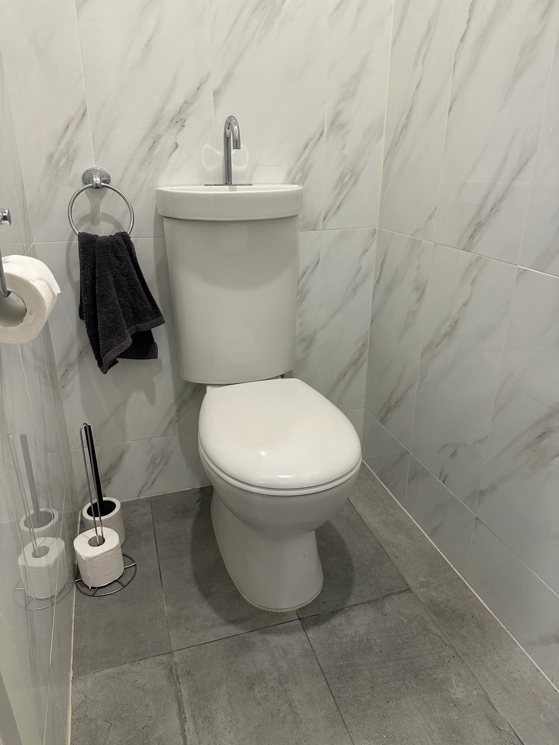 Toilet with a hand basin built into the cistern