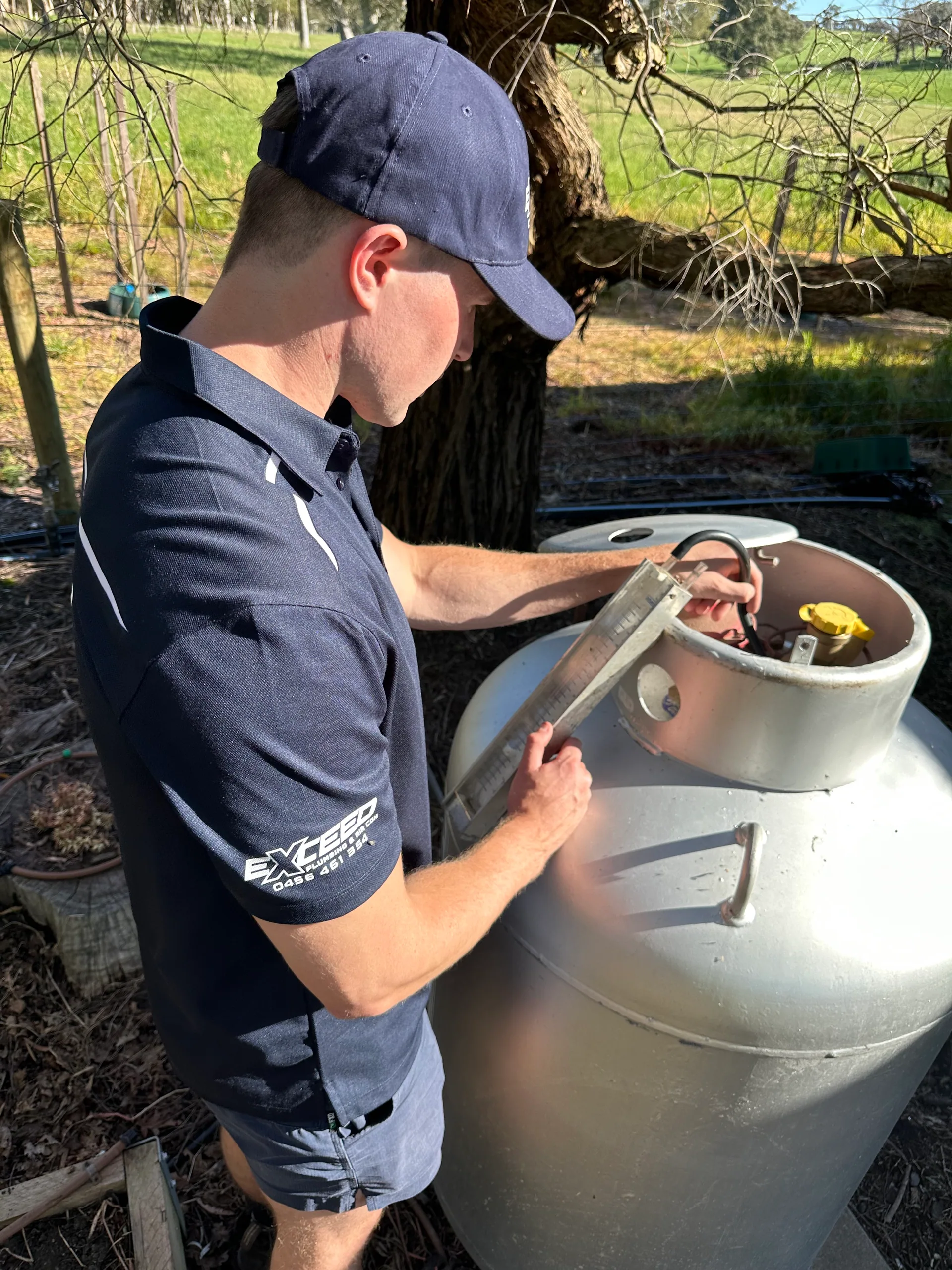 Exceed Plumbing plumber checking an LPG gas cylinder