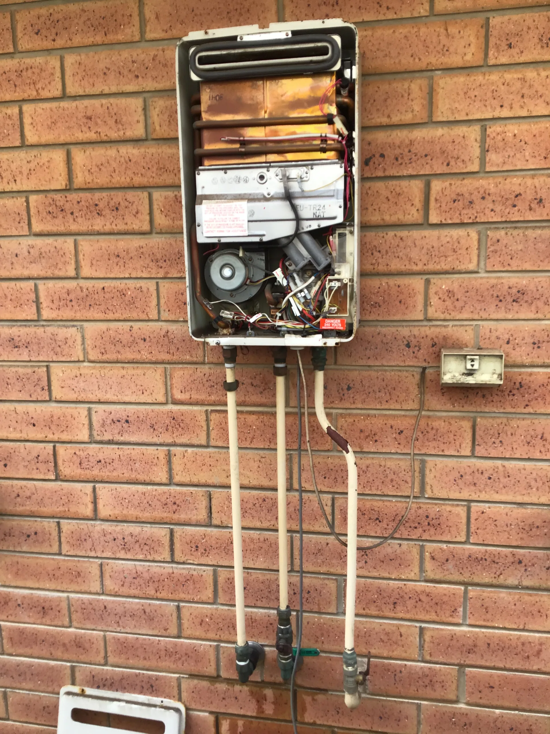 Gas continuous flow hot water unit with its cover off