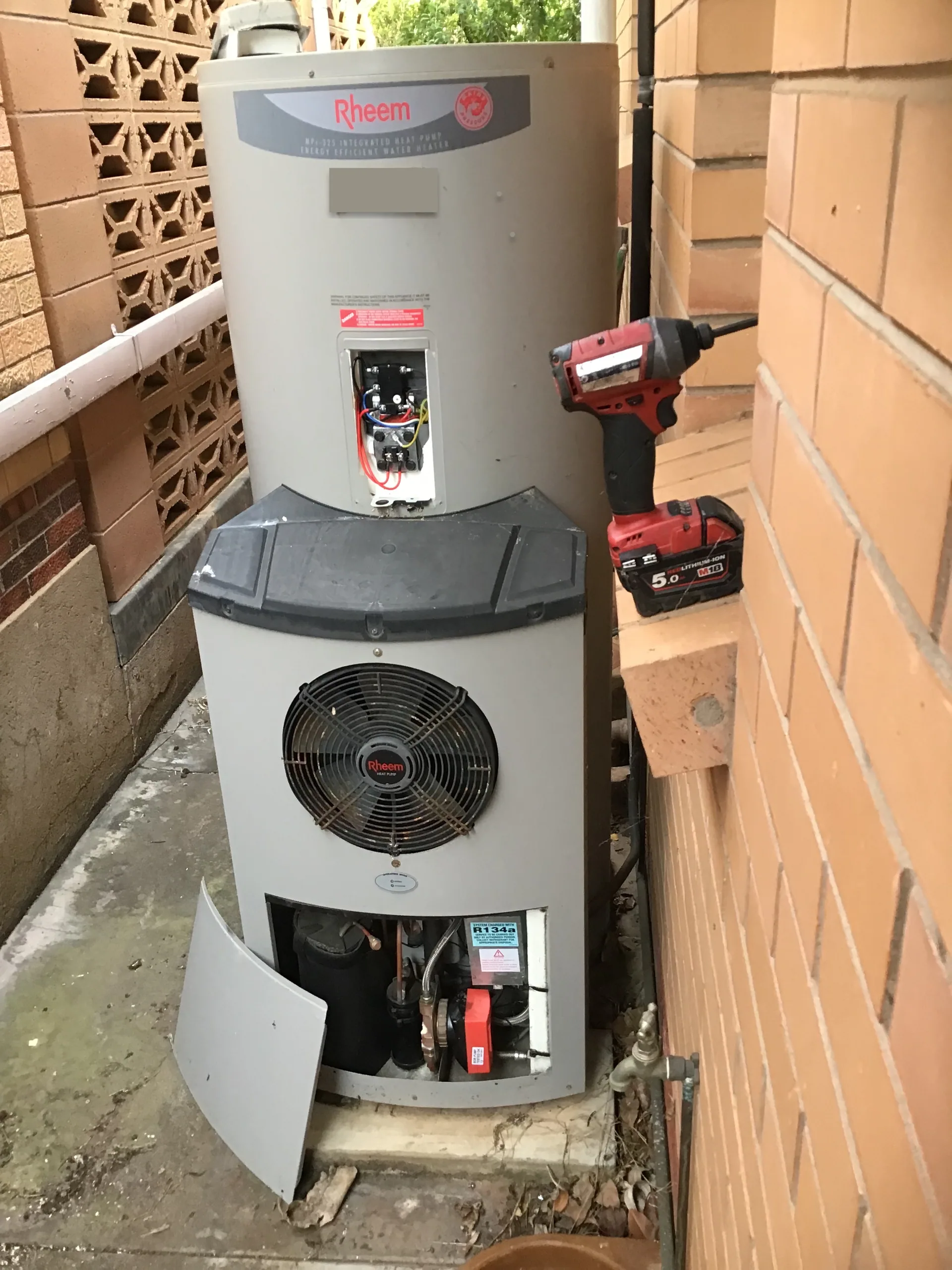 Rheem heat pump hot water system with its lower cover off